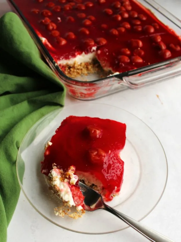 cherry cheesecake pretzel salad served on small plate with fork