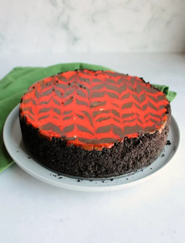 whole chocolate cheesecake with red zig zag pattern baked in.