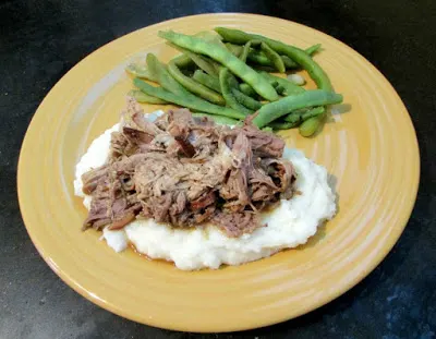 braised pork on mashed potatoes with green beans