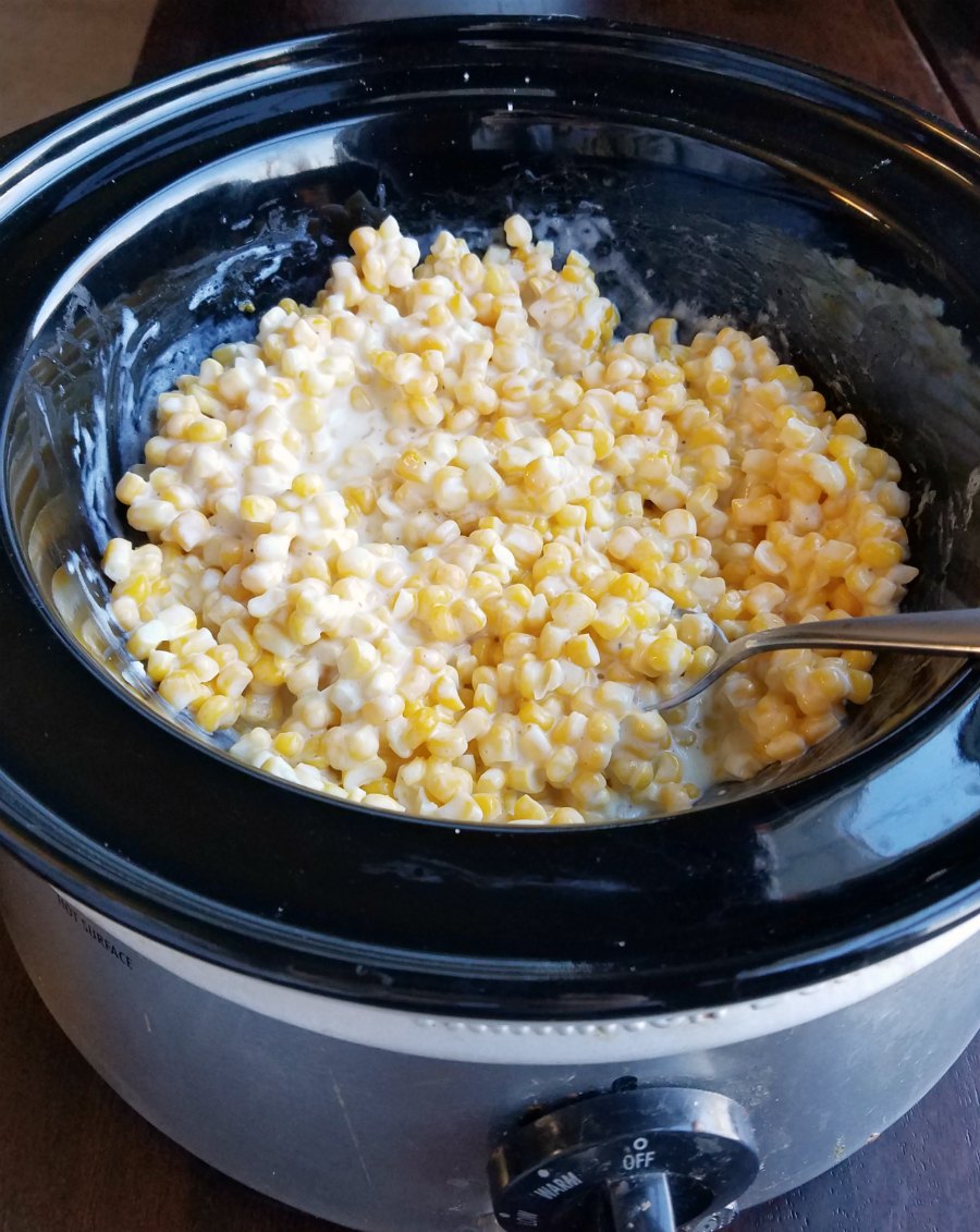 slow cooker full of creamy corn ready to eat.