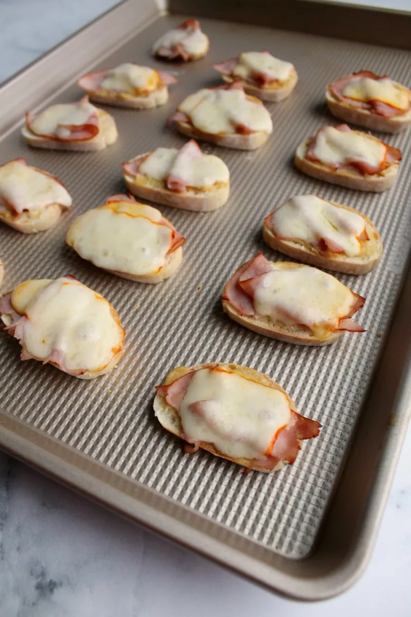 baking tray of ham and cheese crostini fresh from the oven,