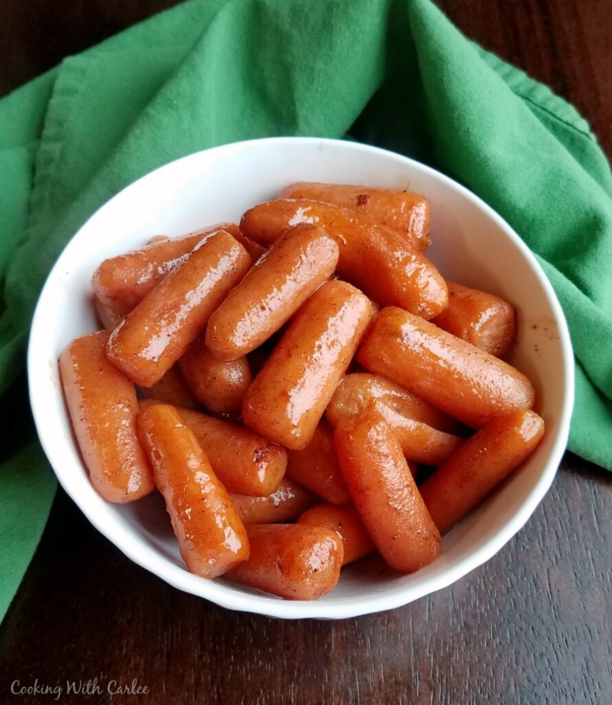 Bowl filled with carrots coated in honey and cinnamon.