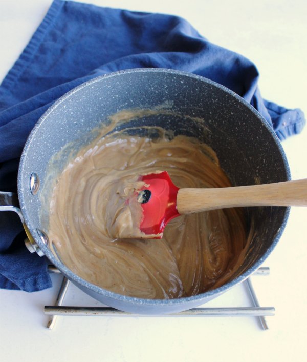 hot peanut butter maple mixture in saucepan.