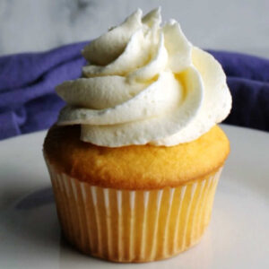 Vanilla cupcake with swirl of white chocolate frosting on top.