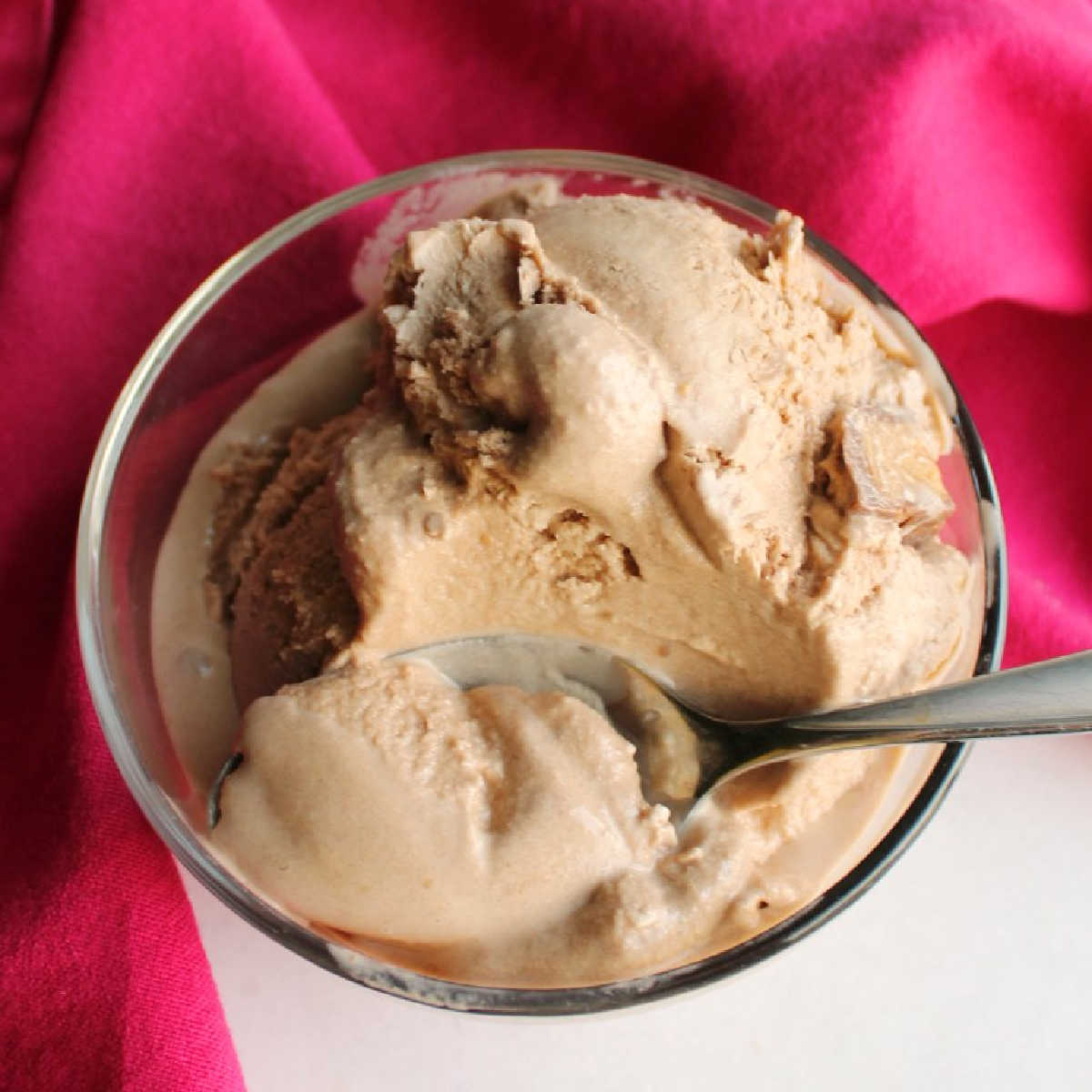 bowl of soft chocolate ice cream with peanut butter chunks.