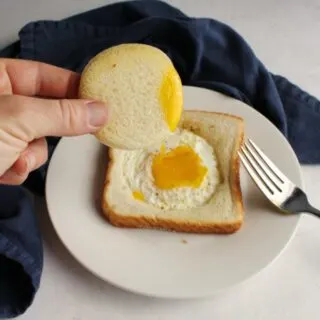 toast with an egg in the middle of it and runny yolk in the center