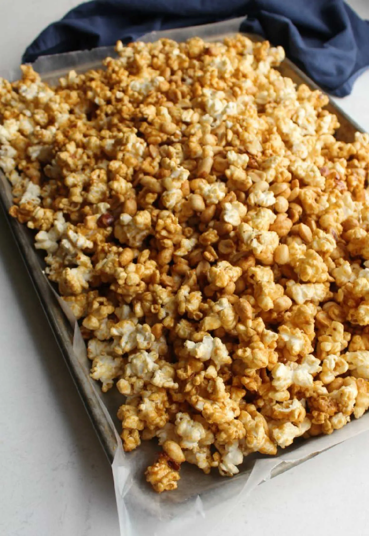 wax paper lined pan filled with cooling caramel corn.
