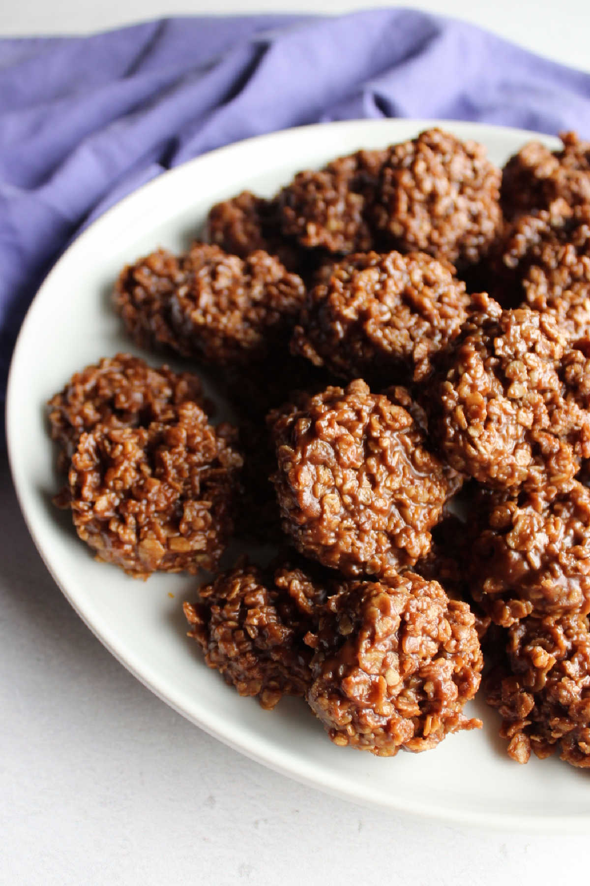 Serving plate pile high with peanut butter chocolate no bake oatmeal cookies. 