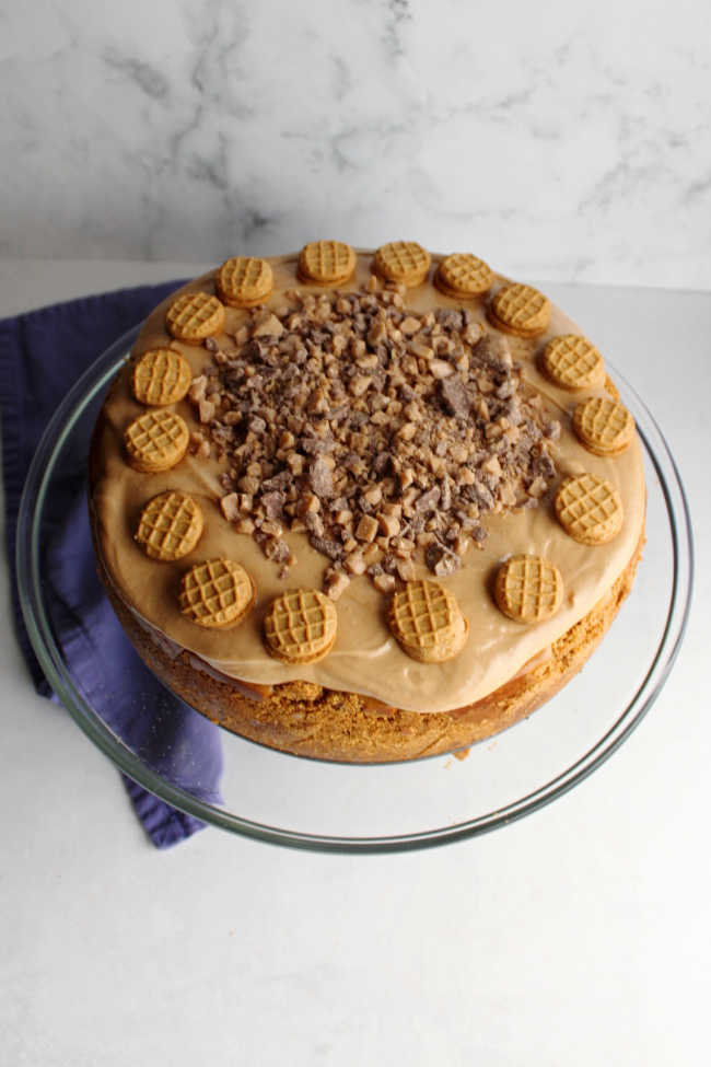 whole peanut butter cheesecake topped with nutter butters and toffee bits