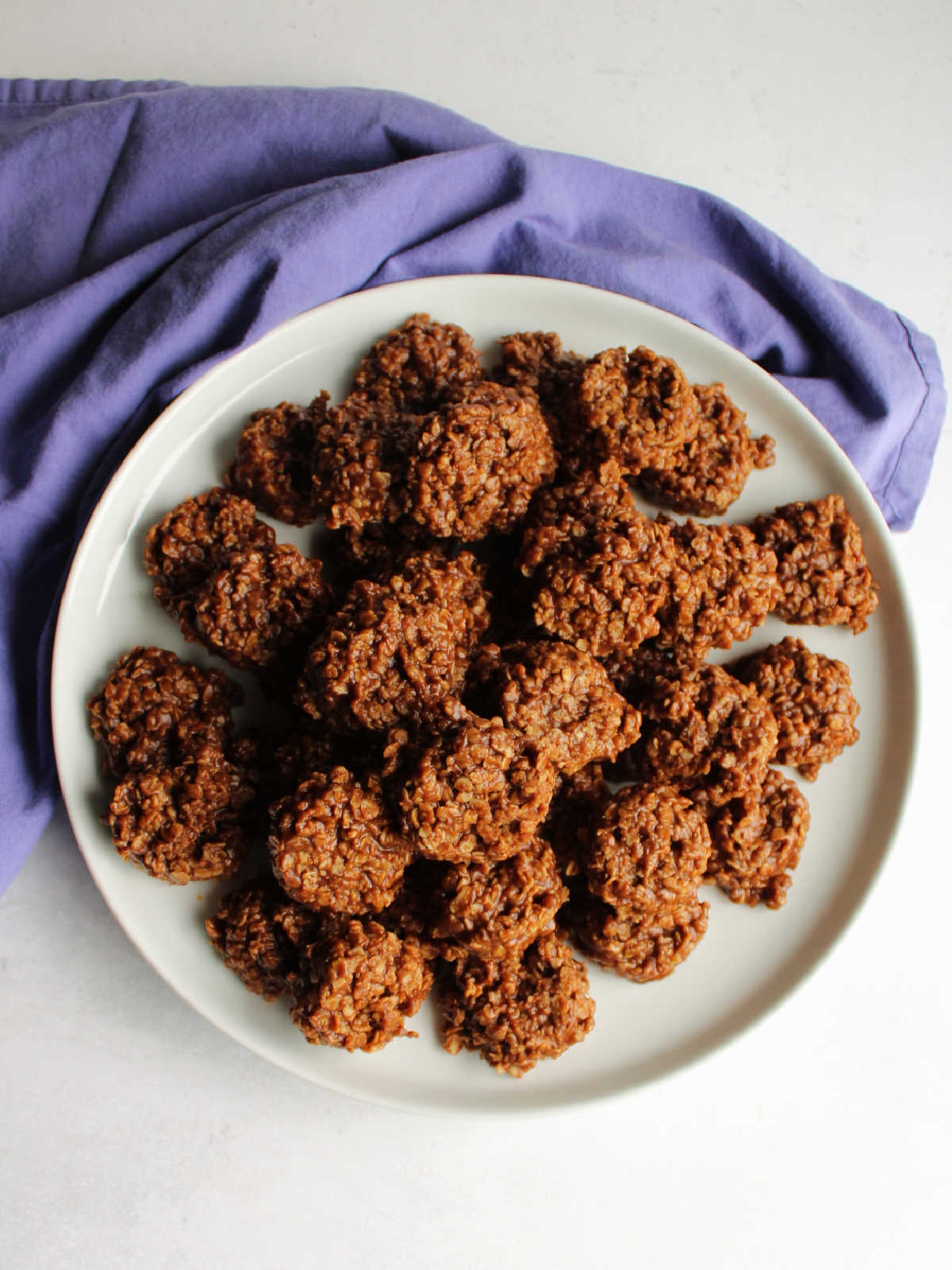 Pile of peanut butter chocolate no bake cookies with oatmeal.