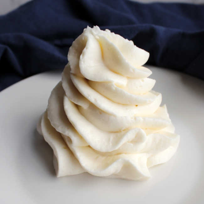 close up of swirl of fluffy whipped cream cheese frosting