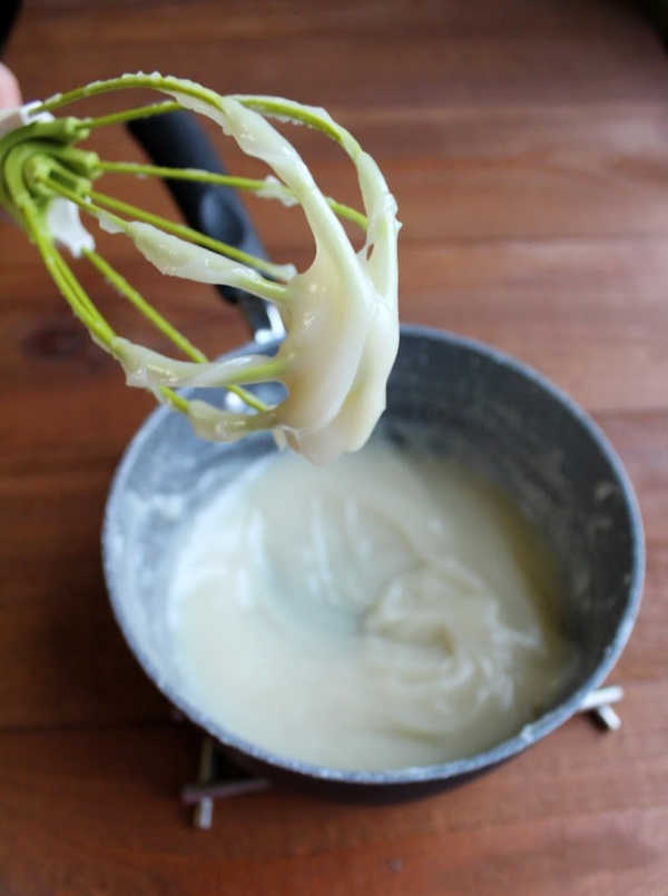 warm thick milk and flour mixture clinging to whisk