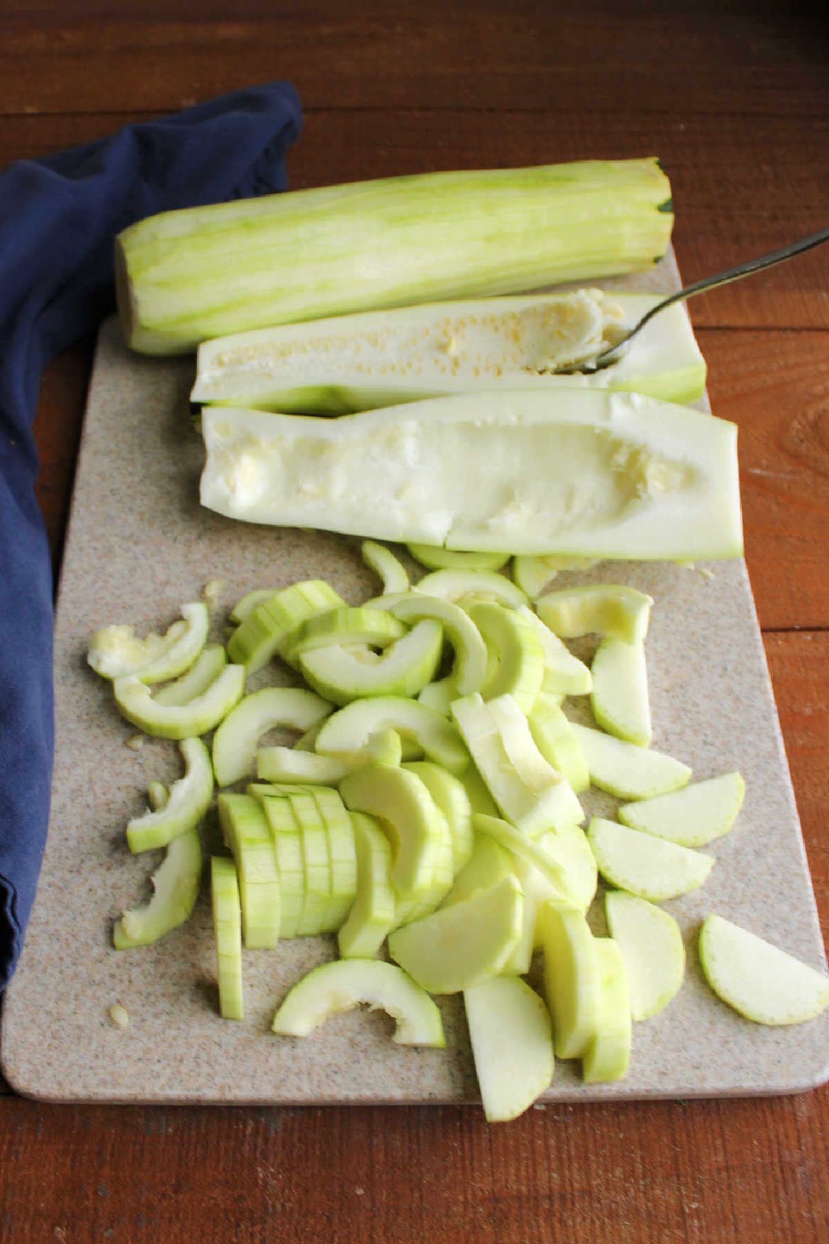Preparing zucchini for the pie by removing the skin and seeds and slicing thinly.