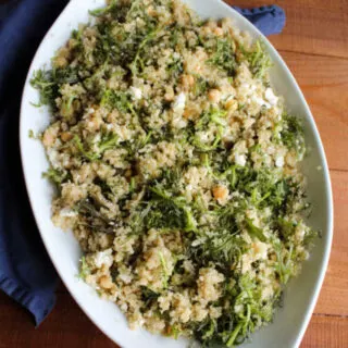 large serving bowl filled with quinoa, feta and fresh greens salad