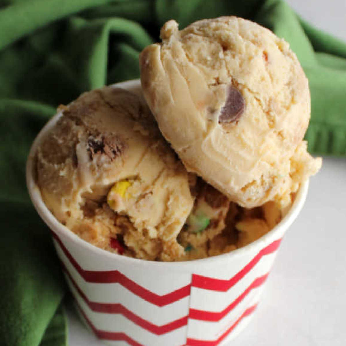 scoops of monster cookie dough with peanut butter, oatmeal and candies inside.