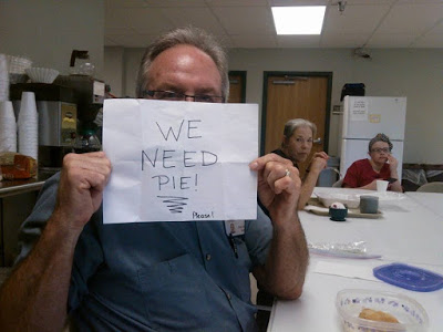 nursing home resident holding up we need pie sign