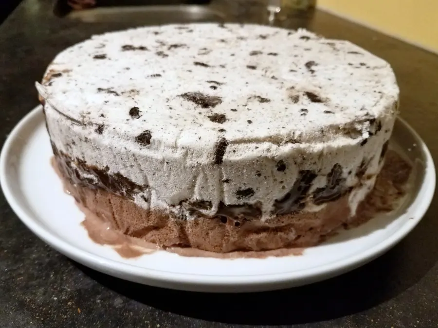 ice cream cake out of pan ready for whipped cream frosting.