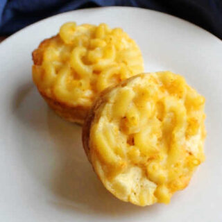 two cheesy macaroni muffins on plate ready to eat.