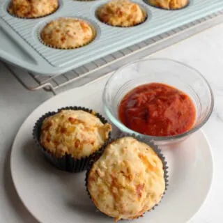 pepperoni pizza muffins and marinara sauce on plate ready to eat