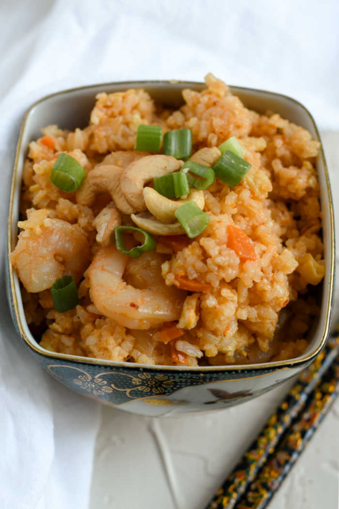 bowl of shrimp fried rice with cashews and scallions