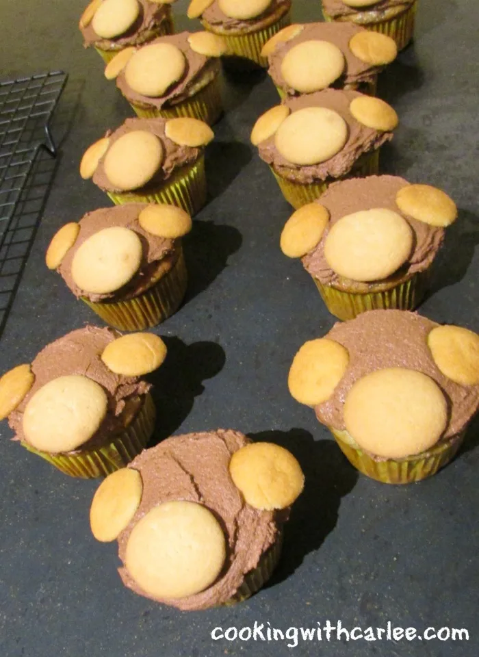 cupcakes with chocolate frosting and nilla wafers ready to be made into monkey faces