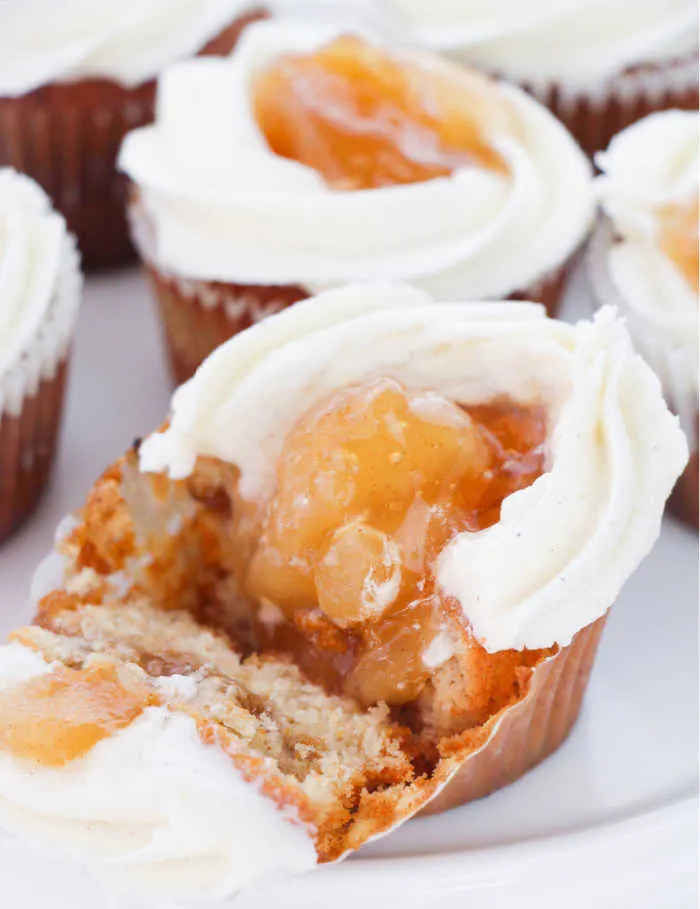 Inside of apple pie filled cupcake with cinnamon buttercream on top.