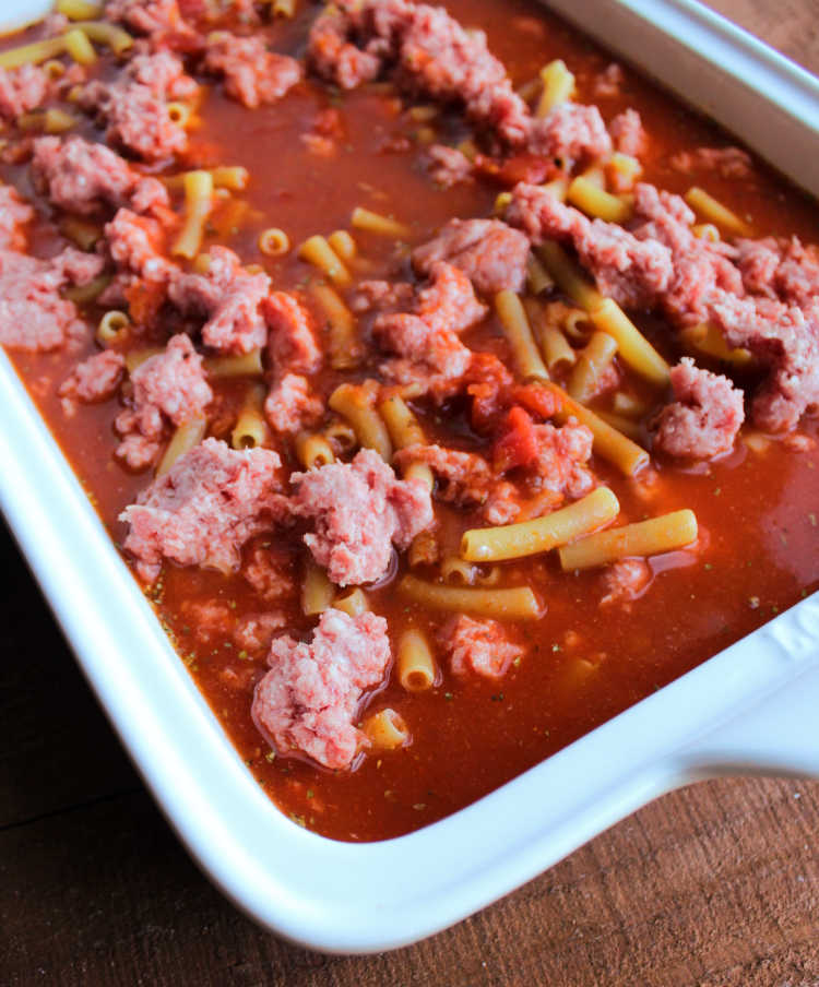 raw pasta and beef in sauce ready to bake.