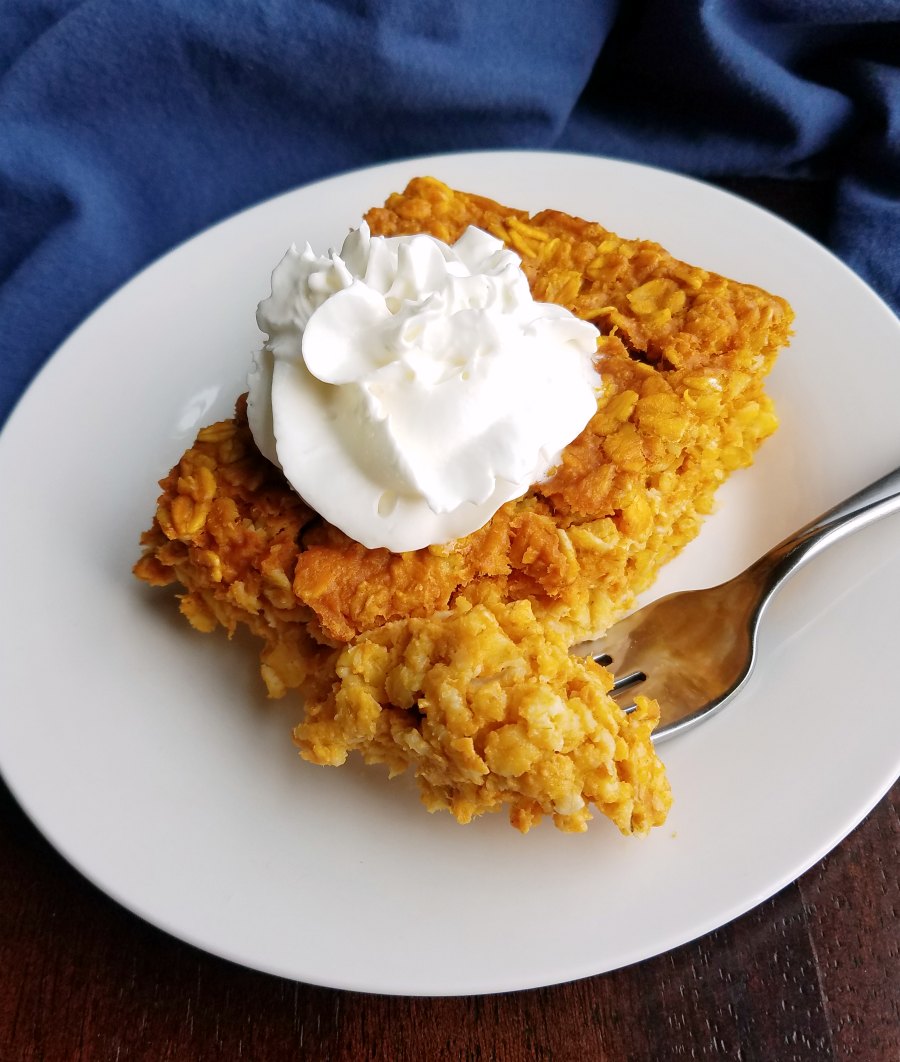 piece of pumpkin baked oatmeal with whipped cream.