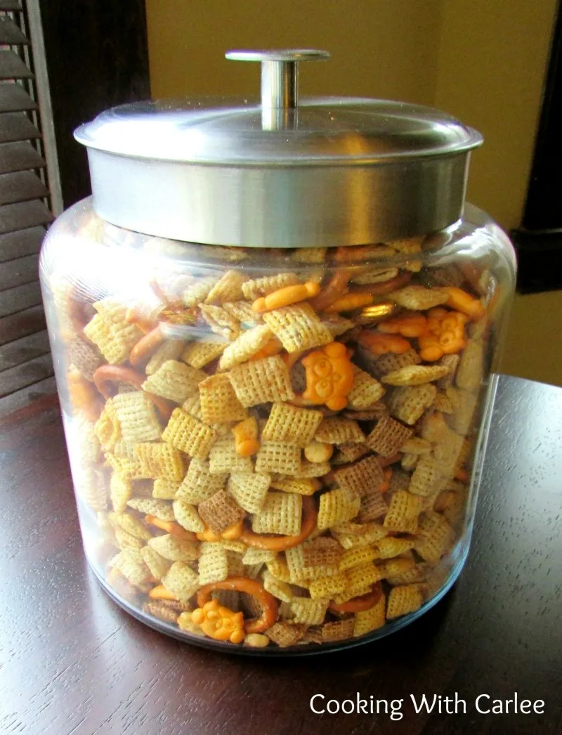 Jar of crunchy chex mix with a variety of cereals, cheese crackers, peanuts and more. 