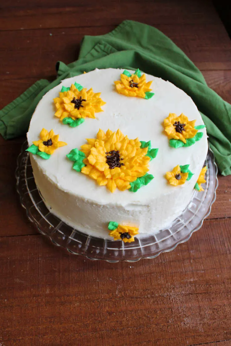 layer cake with 3D frosting sunflowers on top.