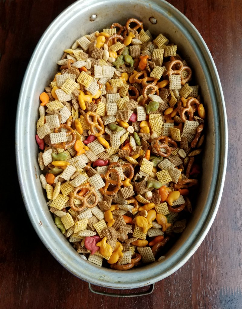 large roasting pan filled with chex mix ingredients ready to bake.