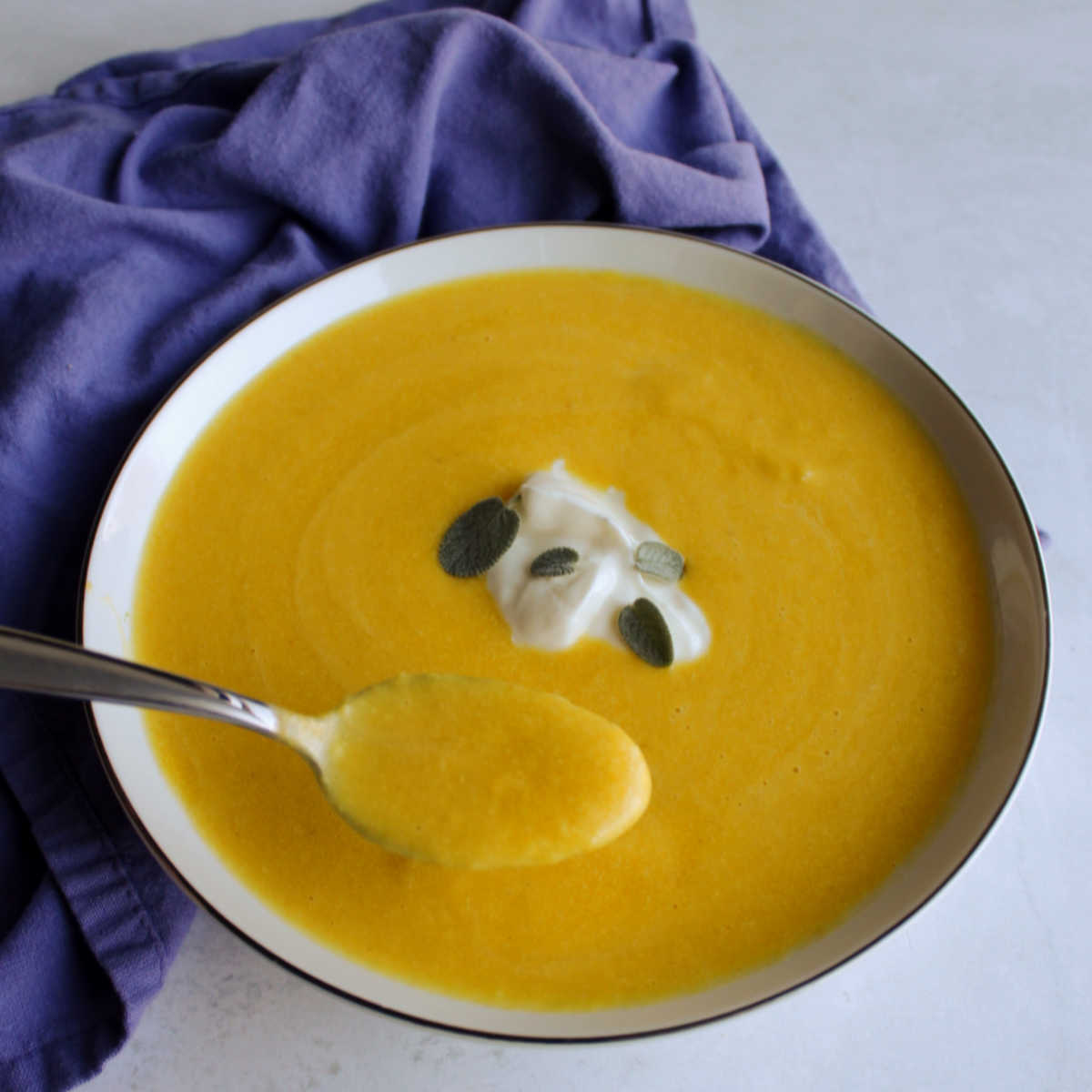 spoonful of creamy pumpkin soup ready to eat