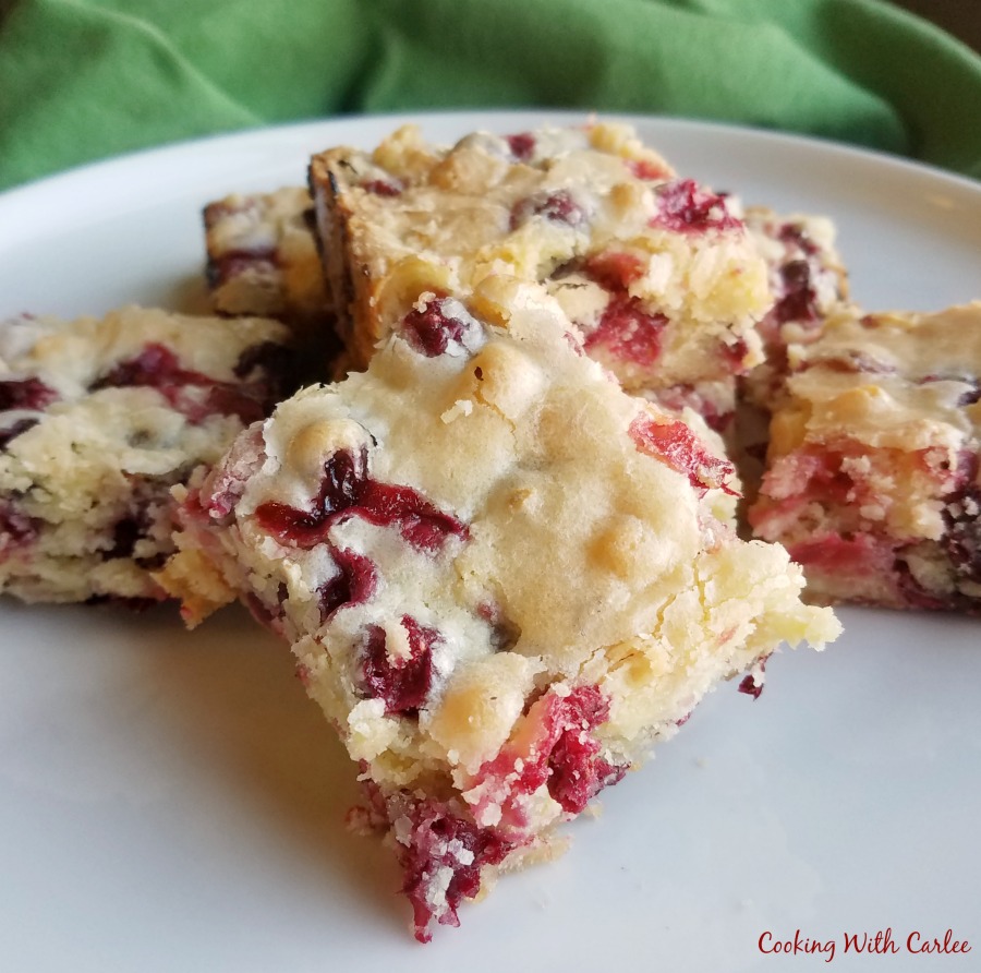squares of cranberry snack cake piled on top of each other. 