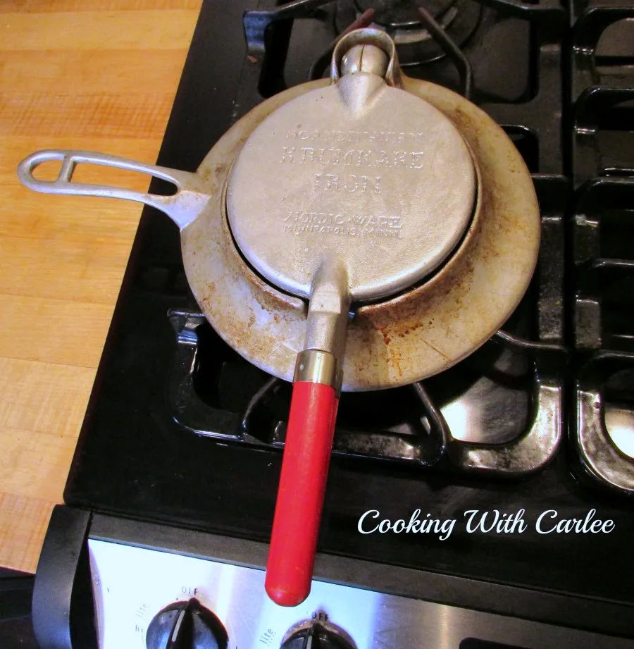 Vintage nordicware krumkake iron on stove.