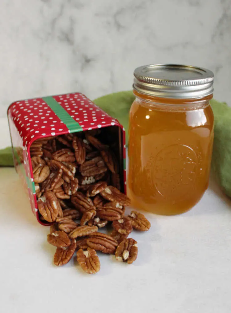 tin of pecans and jar of honey ready to be made into honey coated pecans.
