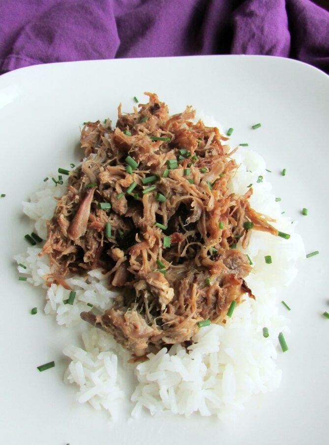 Crockpot Pineapple Pulled Pork 7 pineapple pulled pork served on top of a bed of rice.