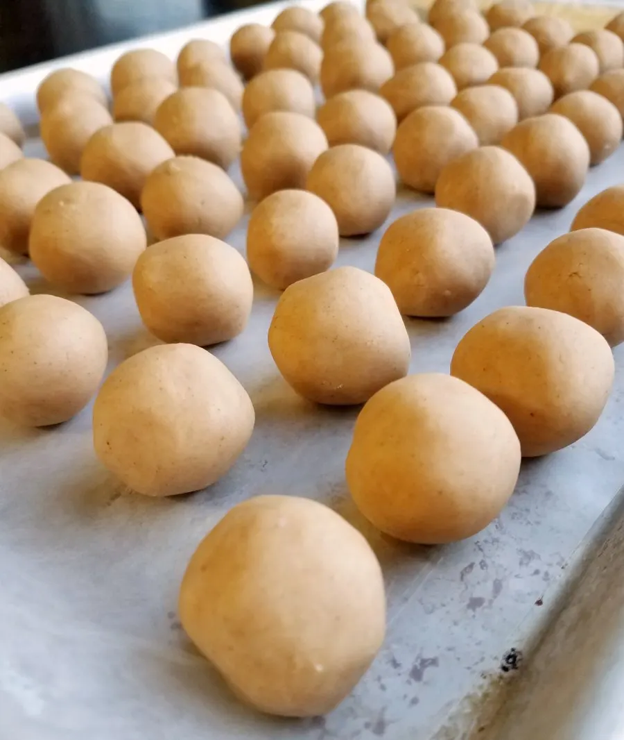 Balls of peanut butter filling ready to be dipped in chocolate.