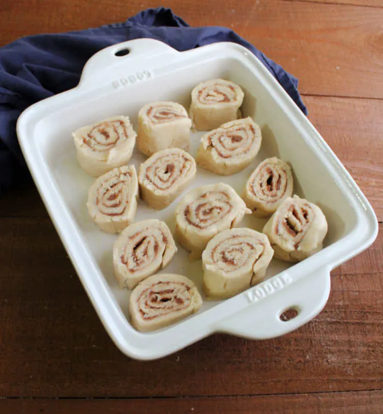 raw cinnamon butter roll swirls in pan.