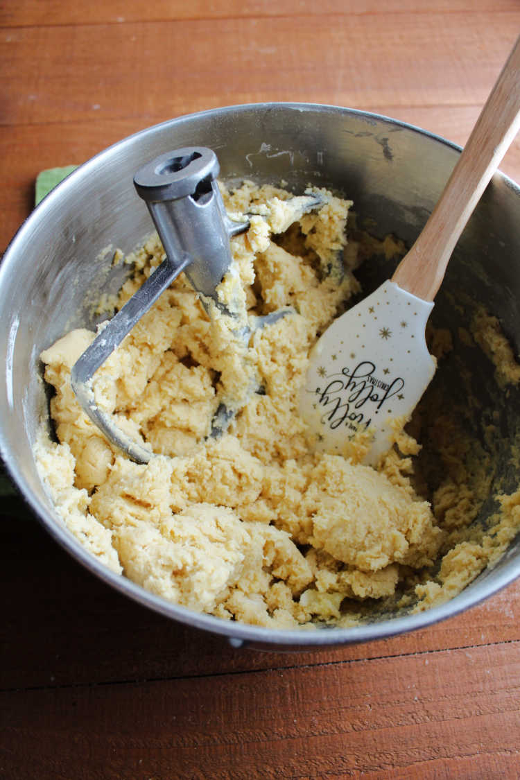 mixer bowl with paddle, sugar cookie dough and spatula.