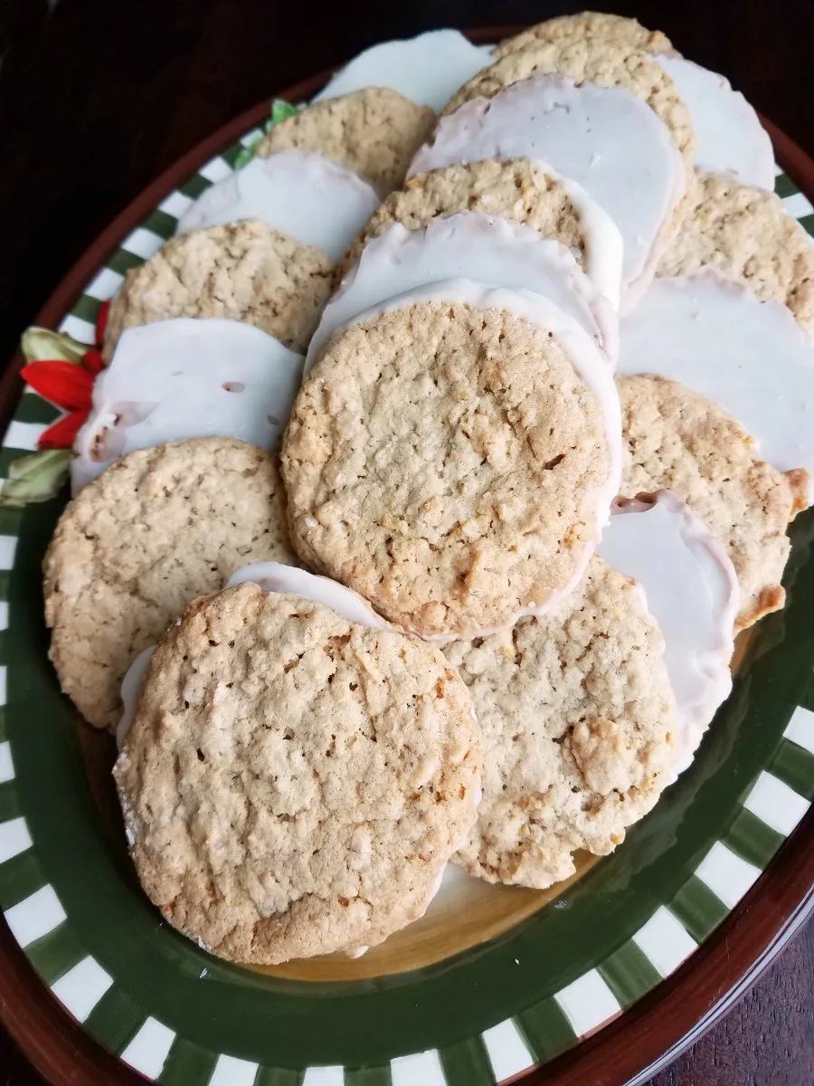 platter of golden christmas cookies dipped in white chocolate.