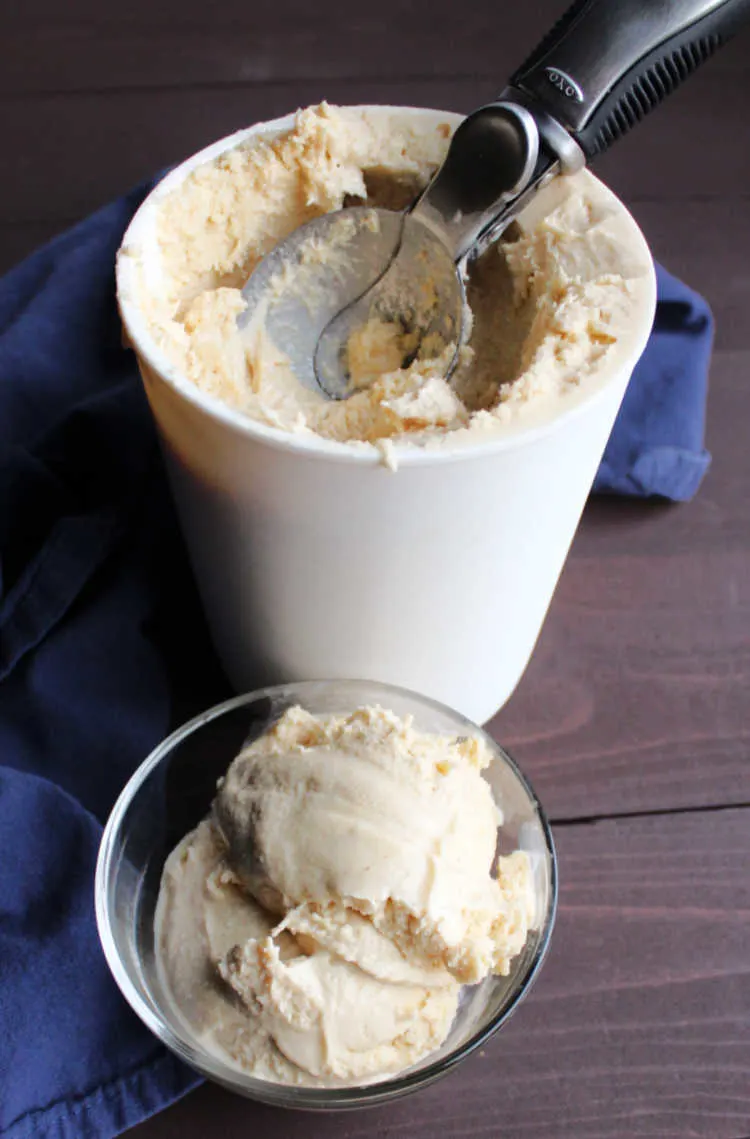 scoop of banana peanut butter ice cream in front of container.