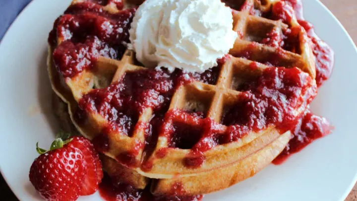 sourdough waffles with strawberry sauce and whipped cream