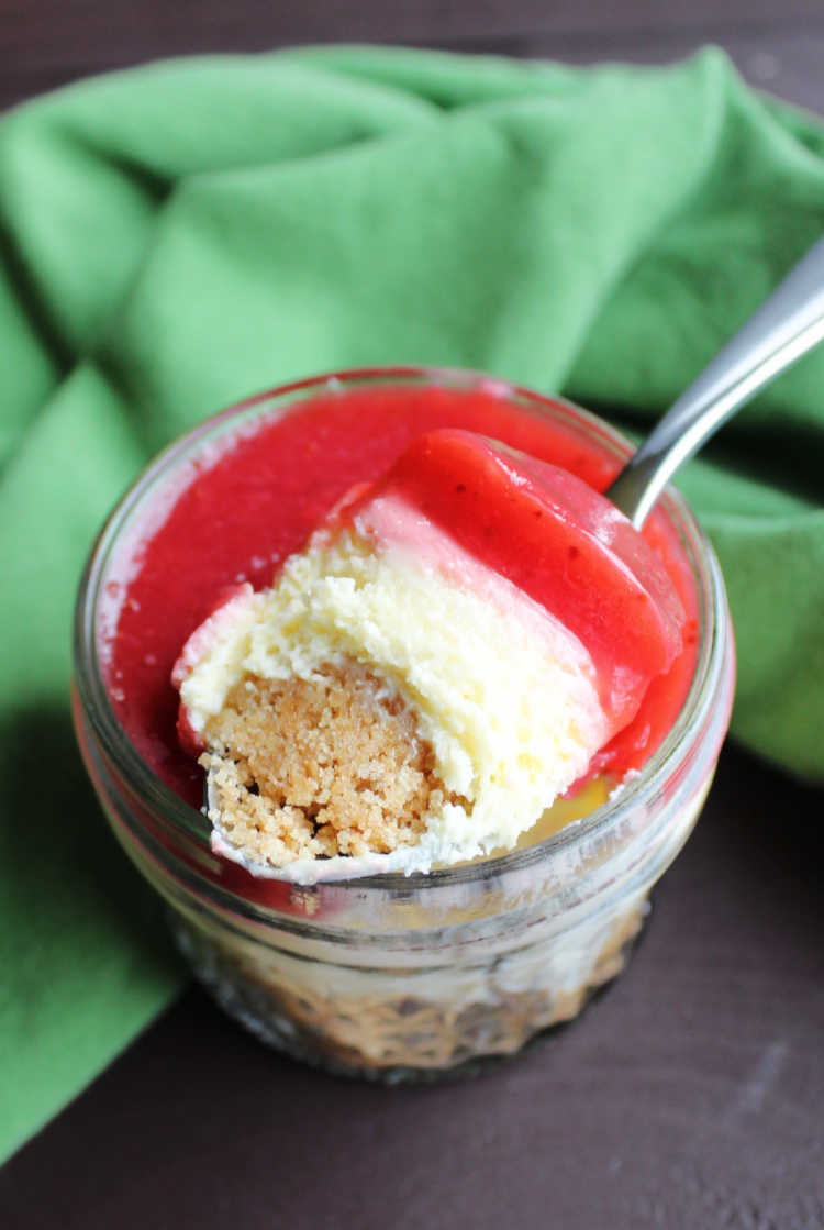 spoonful of cheesecake and strawberry topping ready to eat