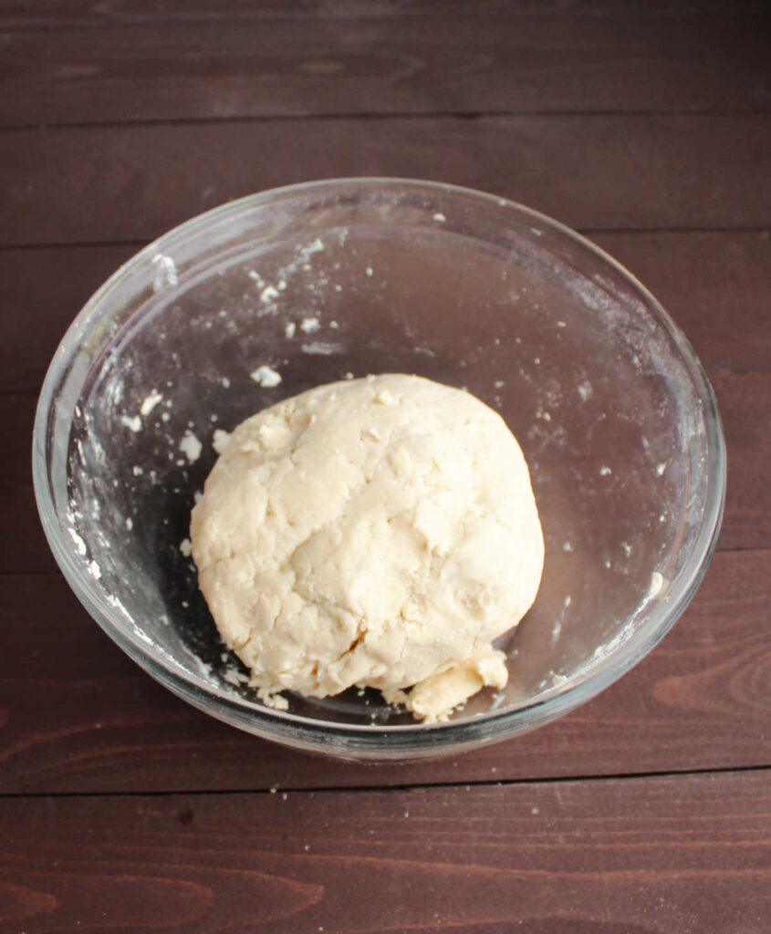 ball of pie crust dough in bowl.