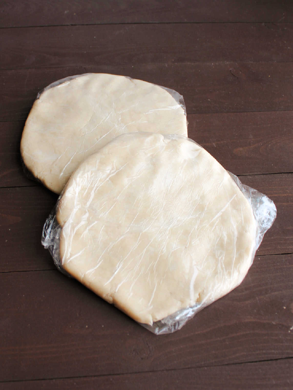 disks of pie crust dough wrapped in plastic wrap to chill.