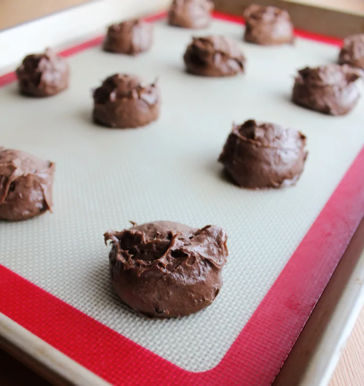 scoops of chocolate whoopie pie batter on cookie sheet