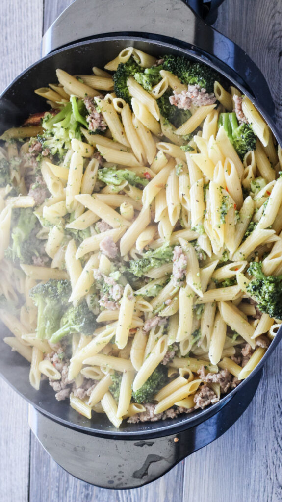 pot of pasta with broccoli and sausage, most of water absorbed