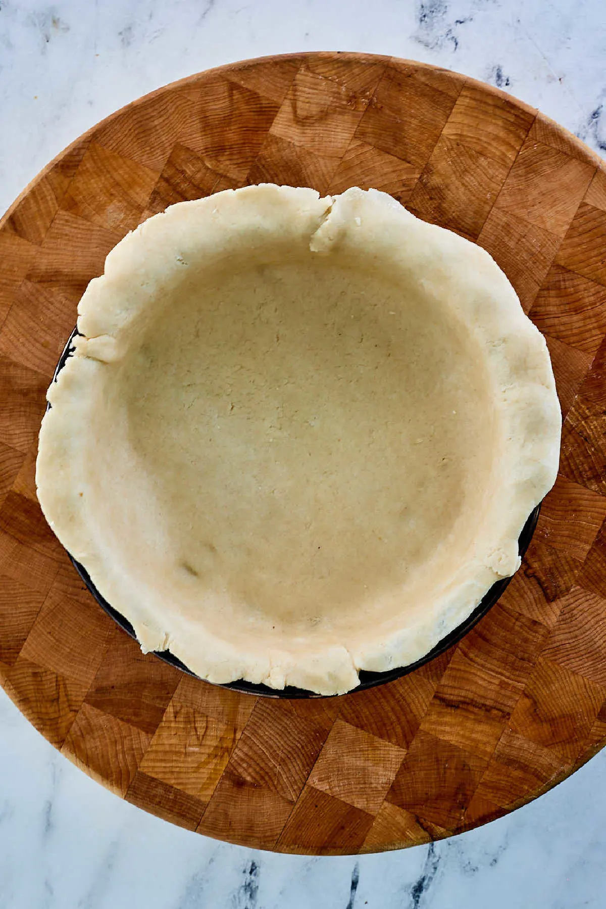Lard pie crust in pie pan ready for filling.