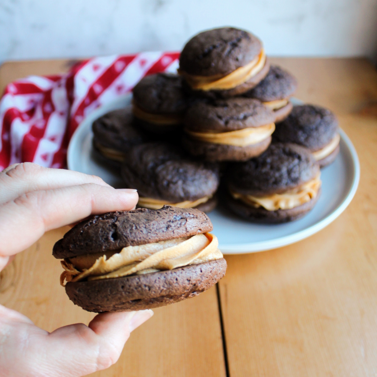 hand holding large chocolate whoopie pie with peanut butter marshmallow filling