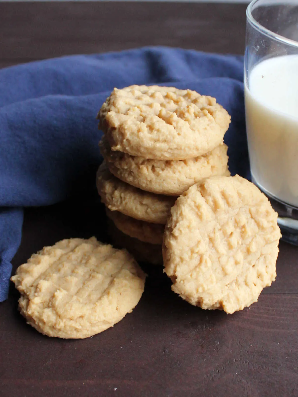 stack of grandma's peanut butter cookies by a glass of milk